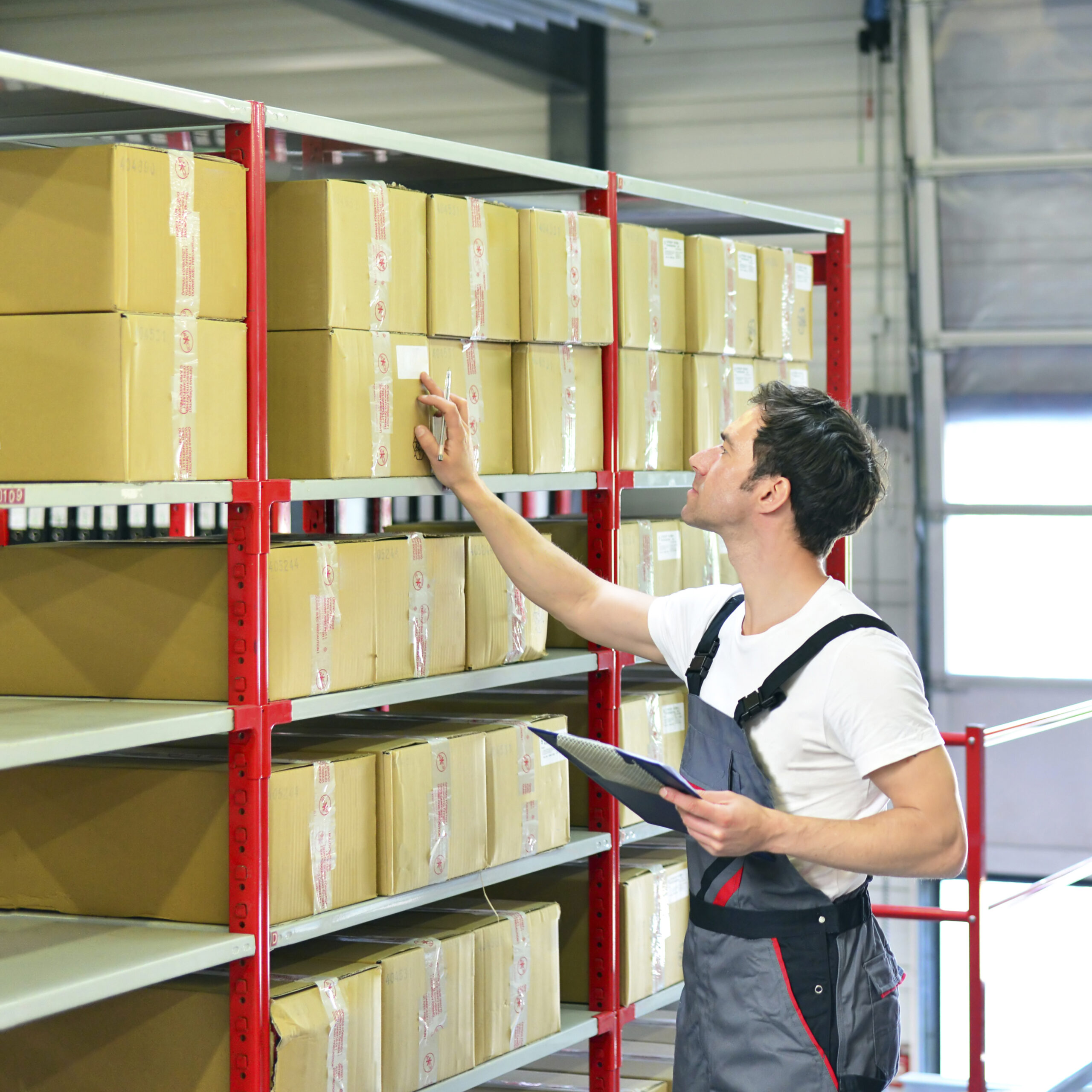 Worker in warehouse controlling goods